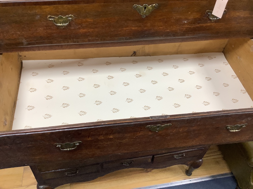 An 18th century cross banded oak chest on stand, width 116cm, depth 57cm, height 170cm
